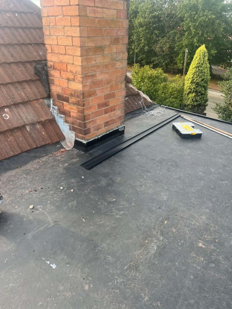 This is a photo of a flat roof which has just been repaired, there is also a chimney stack and some leadwork has also been dressed. Works carried out by MCM Roofing Repairs Hook